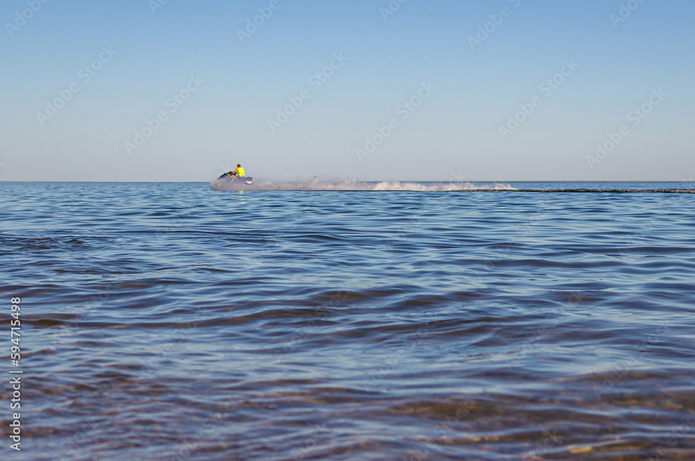 Man driving a jetski on the sea beach
