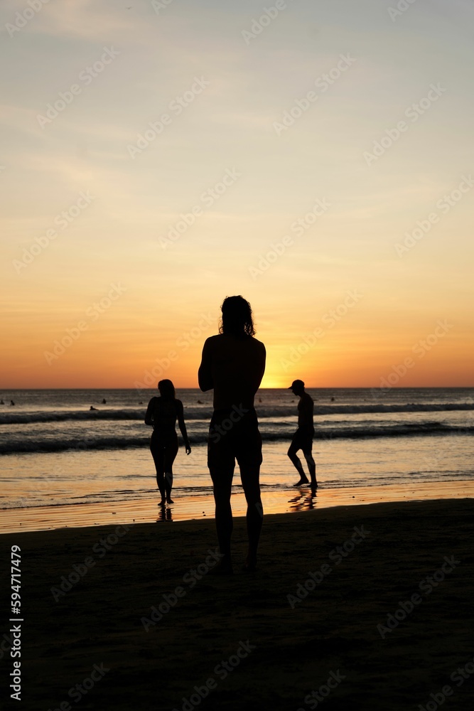 Group of friends enjoying a vibrant beach sunset