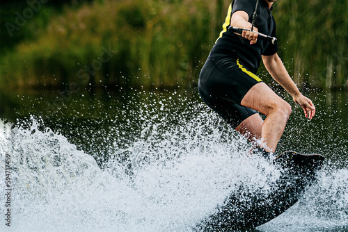 Schilderij op canvas man wakeboarding behind motorboat on lake, extreme water sports, summer vacation