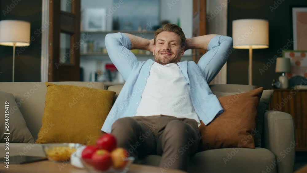 Handsome guy chilling couch cozy living room. Carefree man relaxing in evening Handsome guy chilling couch cozy living room. Carefree man relaxing in evening
