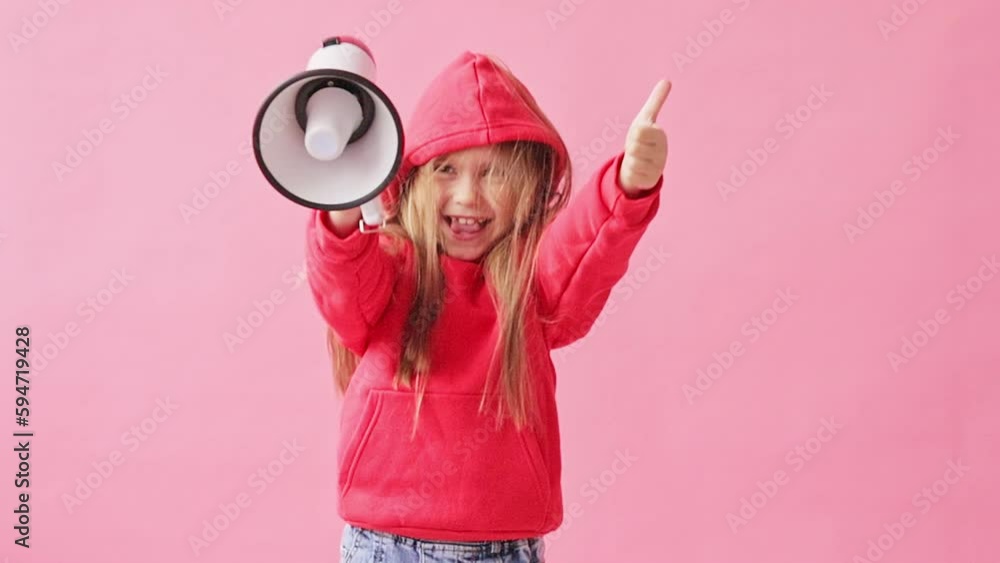 portrait of a girl in a red jacket and with a megaphone in her hands, pink background portrait of a girl in a red jacket and with a megaphone in her hands, pink background