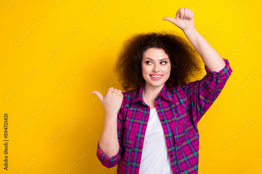 Photo of young girl wear magenta plaid shirt funny indicating fingers empty space look interesting amusement park isolated on yellow color background Photo of young girl wear magenta plaid shirt funny indicating fingers empty space look interesting amusement park isolated on yellow color background