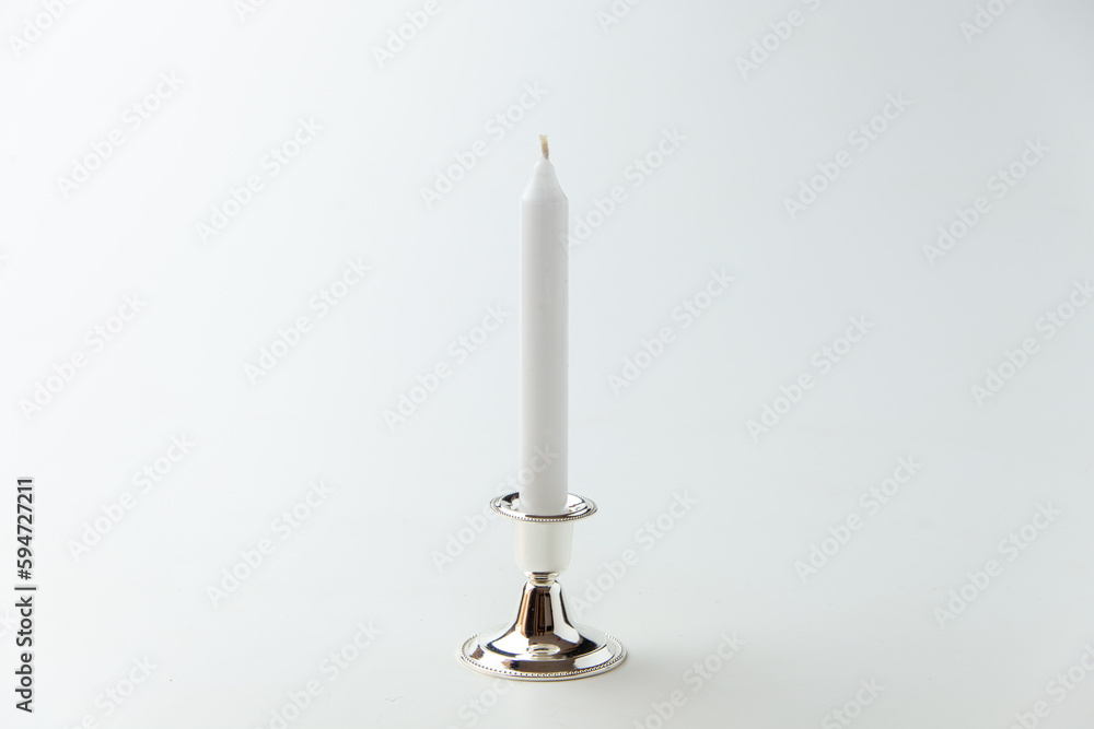 white candle inside silver candlestick on white background flame lamp fire steel metallic white candle inside silver candlestick on white background flame lamp fire steel metallic