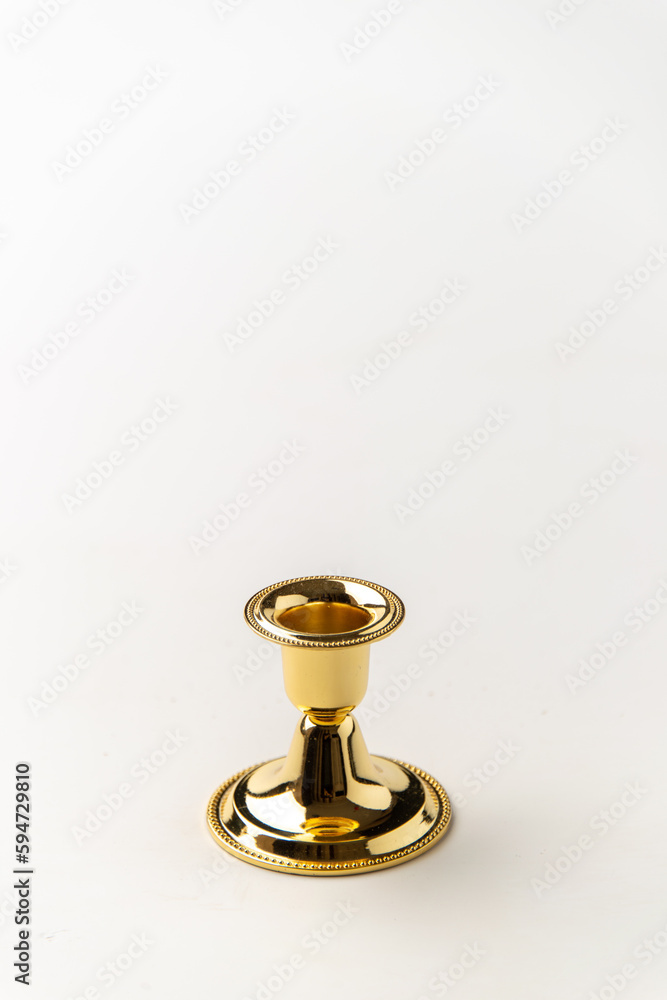 front view of golden candlestick on white surface metallic steel lamp front view of golden candlestick on white surface metallic steel lamp
