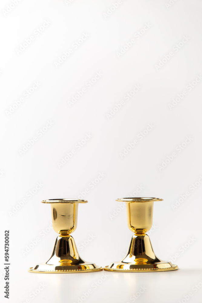 front view of golden candlesticks on the white background metallic steel lamp front view of golden candlesticks on the white background metallic steel lamp