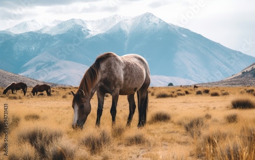 A horse grazing in a field with mountains in the background, Generative AI © amankris99