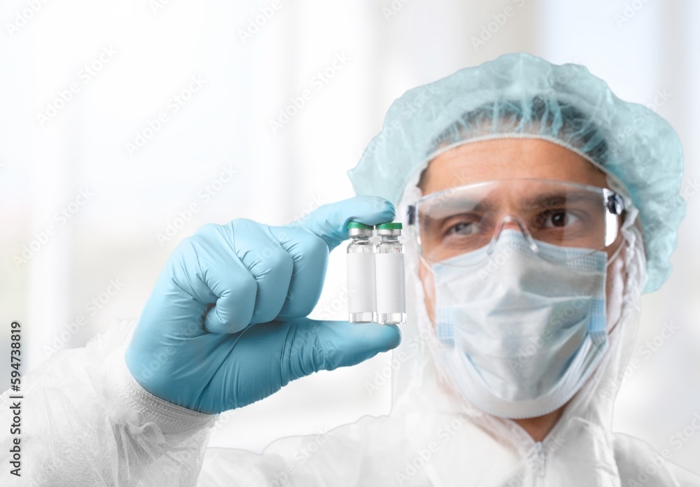 Serious scientist hold medical vials Serious scientist hold medical vials