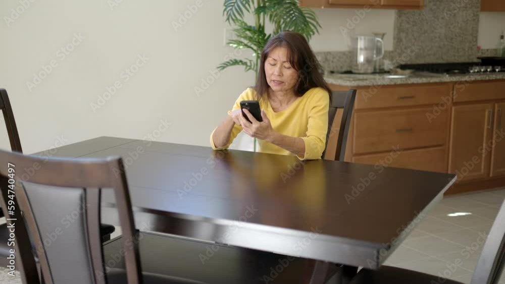 Attractive woman sitting at table online shopping with mobile cell phone excited, happy at successful purchase Attractive woman sitting at table online shopping with mobile cell phone excited, happy at successful purchase