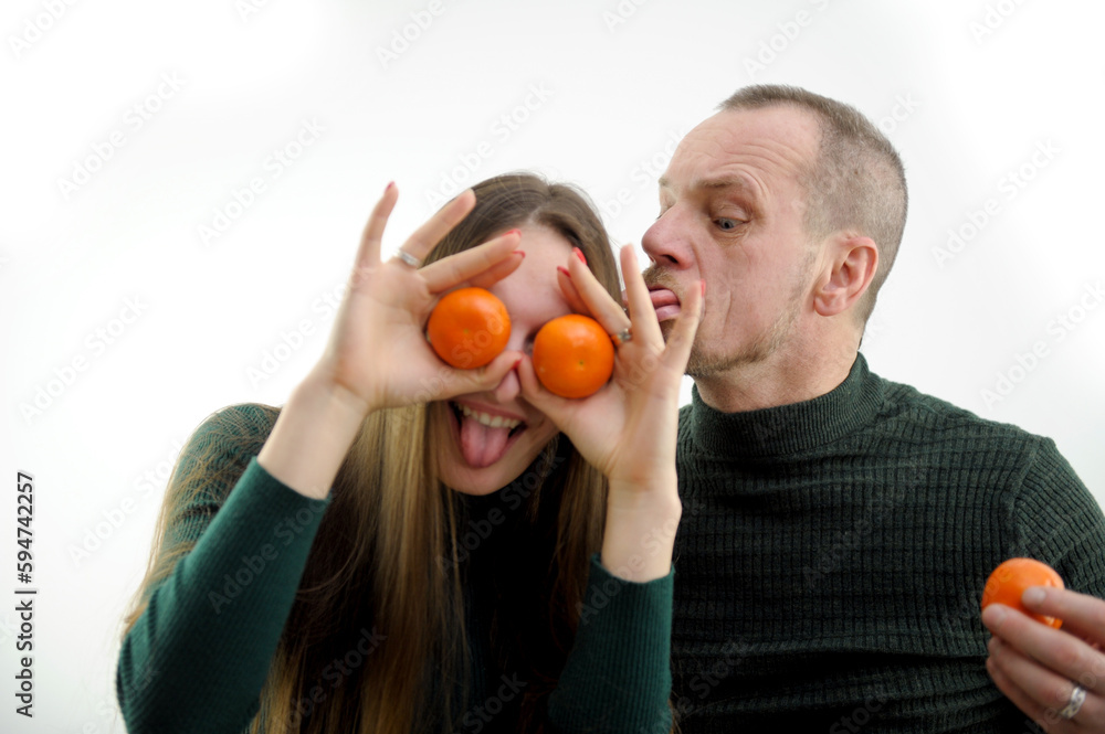 man fooling around like animal licking woman with tongue in the ear showing tongues sticking out tongues at the camera presenting tangerines to the eyes love relationship strange mutual understanding man fooling around like animal licking woman with tongue in the ear showing tongues sticking out tongues at the camera presenting tangerines to the eyes love relationship strange mutual understanding
