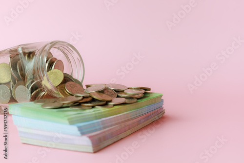 A glass jar of coins with b...