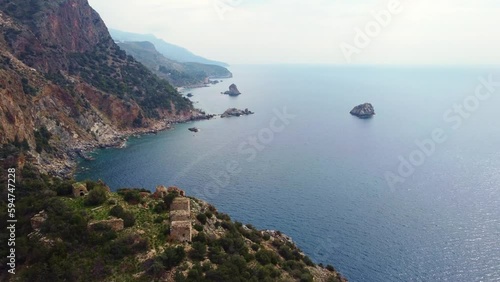 Aerial view of the ruins of an ancient fortress on the top of the mountain.  photo