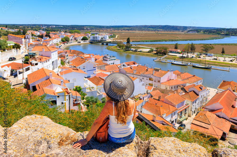 Fototapeta premium Woman tourist looking at panoramic view of Alcacer do sal, touristic village in Portugal- Alentejo