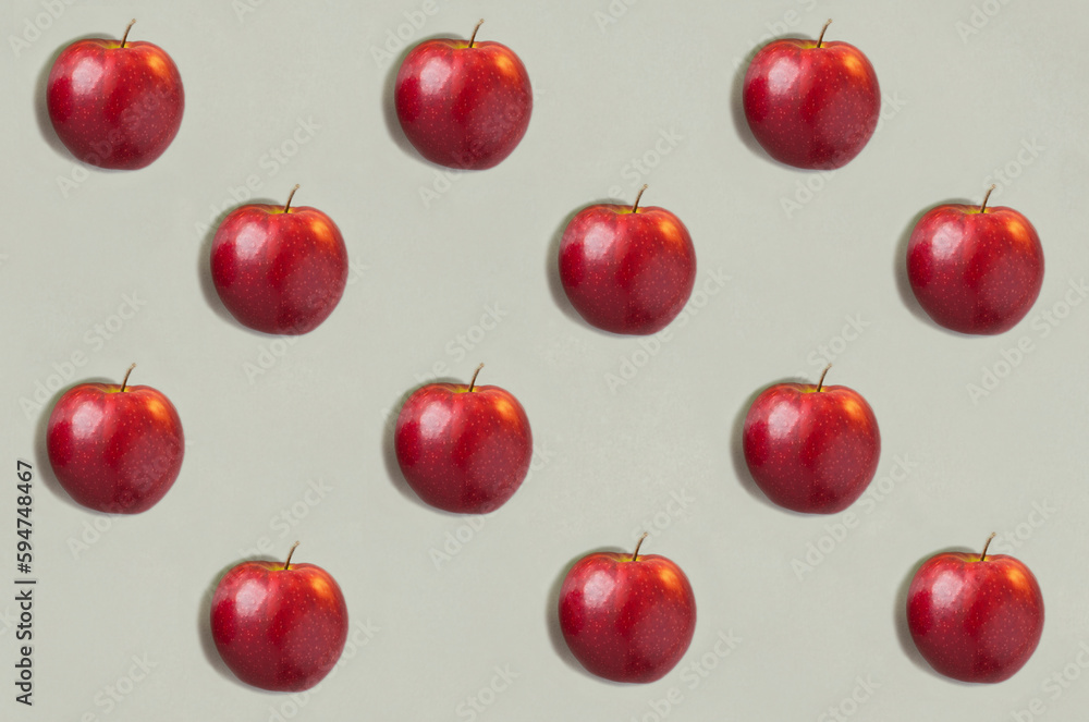 Red apples on the gray background. Flat lay. Pattern. Top view. Red apples on the gray background. Flat lay. Pattern. Top view.