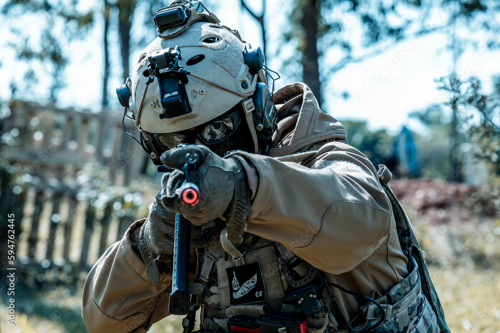 Anonymous soldier with AK-47 in the middle of the battlefield