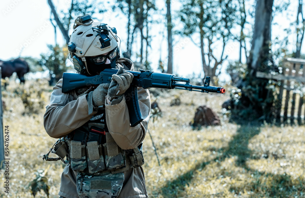 Anonymous soldier with AK-47 in the middle of the battlefield Anonymous soldier with AK-47 in the middle of the battlefield