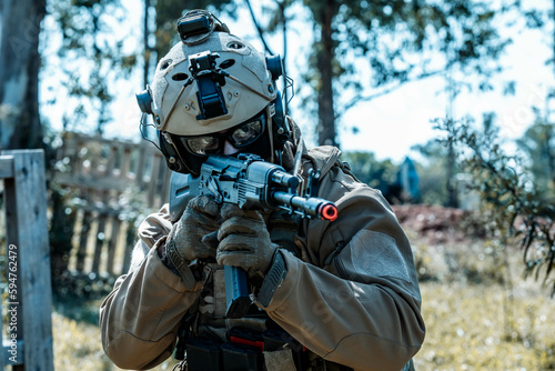 Anonymous soldier with AK-47 in the middle of the battlefield