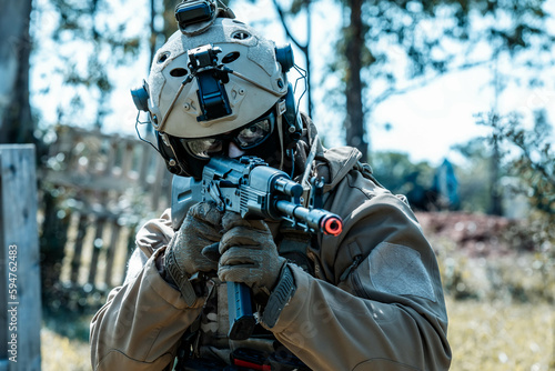 Anonymous soldier with AK-47 in the middle of the battlefield