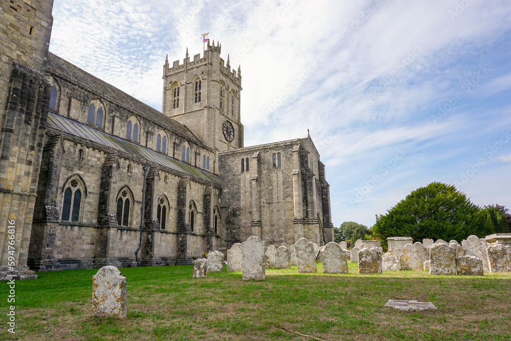 Church Priory in picturesque English town. exterior of wonderful stone church in gothic style architecture 