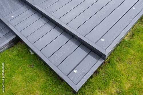 Ash grey composite decking on a rainy wet day showing the full grain of the decking boards A good background image
