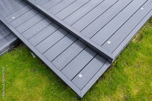 Fotografija Ash grey composite decking on a rainy wet day showing the full grain of the deck