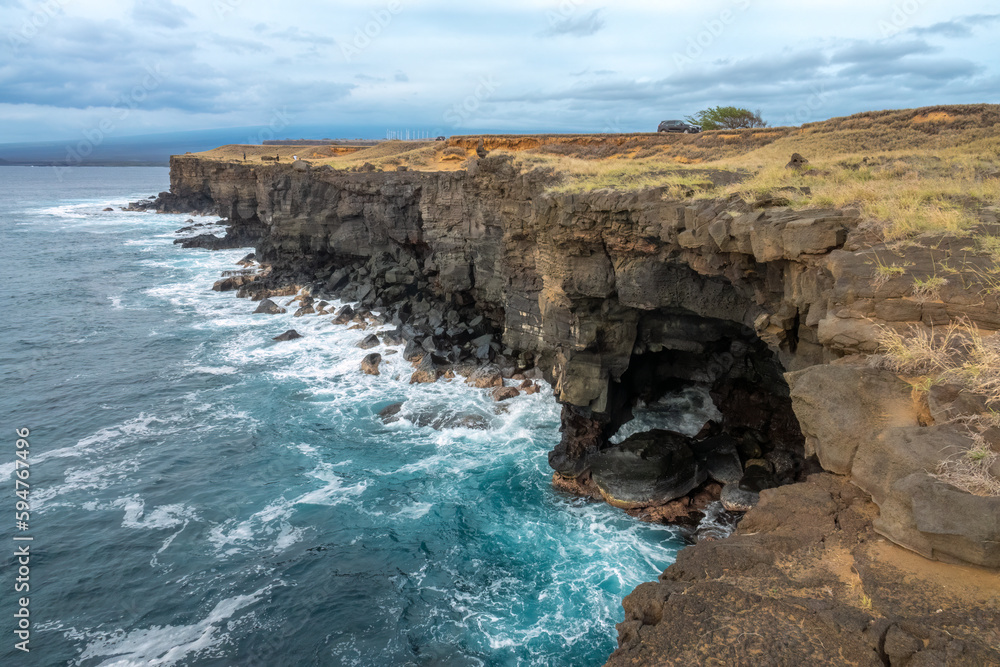 The Holei Sea Arch along the rugged coast of the Volcanoes National Park on Hawaii Big Island, created by lava flows from the Kilauea volcano. Hawaii, USA