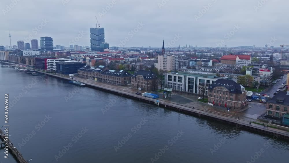 Drone shot of a Modern architecture buildings and famous skyscrapers along part of the banks of the Spree river , Friedrichshain district , Berlin , Germany Drone shot of a Modern architecture buildings and famous skyscrapers along part of the banks of the Spree river , Friedrichshain district , Berlin , Germany
