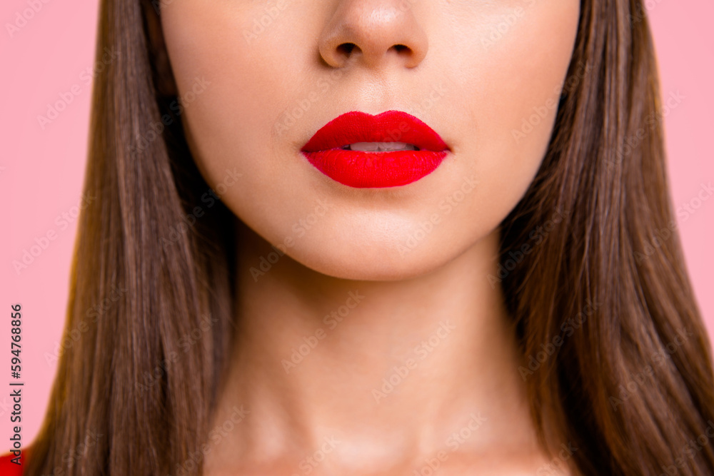 Close up half face crop portrait of brunette woman with red lips slightly opened her mouth isolated on vivid yellow background Close up half face crop portrait of brunette woman with red lips slightly opened her mouth isolated on vivid yellow background