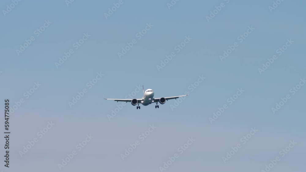 Passenger plane approaching before landing. Long shot of aircraft descending. Airplane flies high in the sky. Tourism and travel concept Passenger plane approaching before landing. Long shot of aircraft descending. Airplane flies high in the sky. Tourism and travel concept