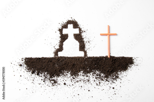 top view of cross shape with dark soil on a white surface grim reaper death funeral