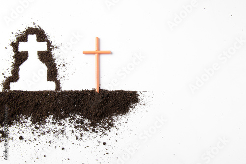 top view of cross shape with dark soil on white surface grim reaper death