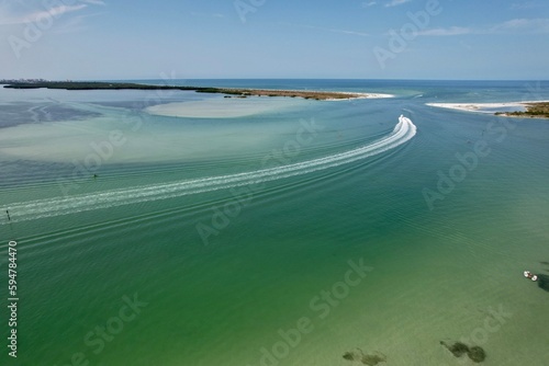 An aerial drone view of Caladesi Island, Dunedin, Florida, beautiful white beaches, and blue, green waters of the Gulf of Mexico.