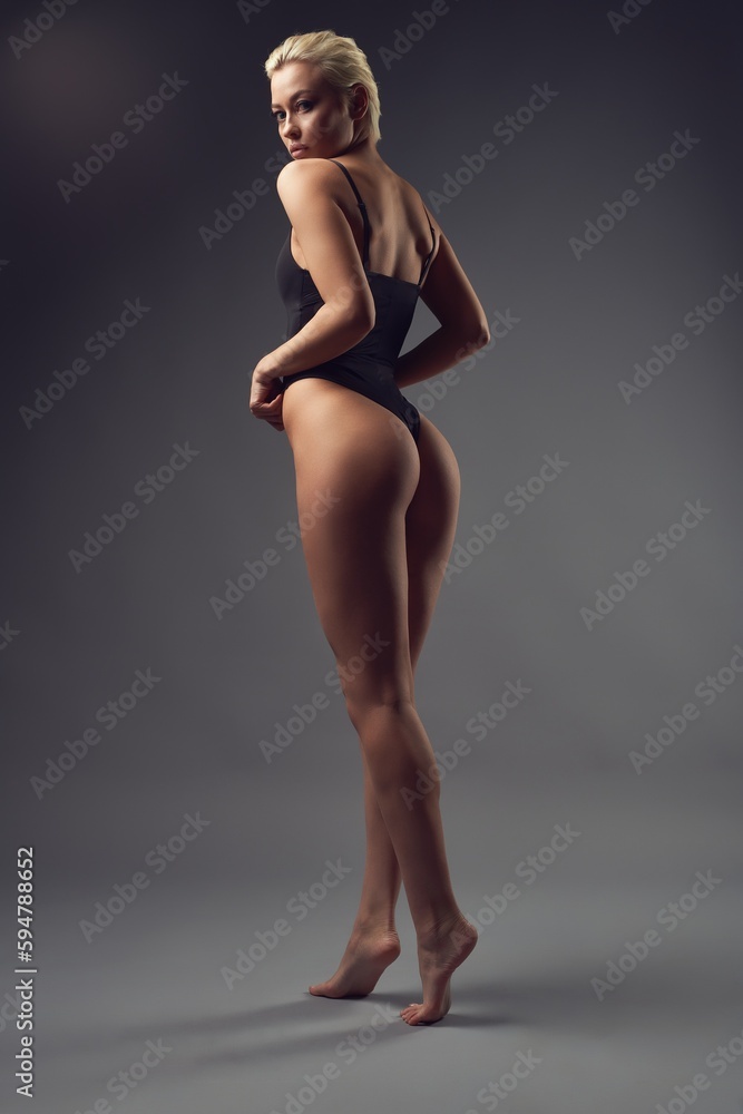 Alluring slim woman with bare buttocks in studio