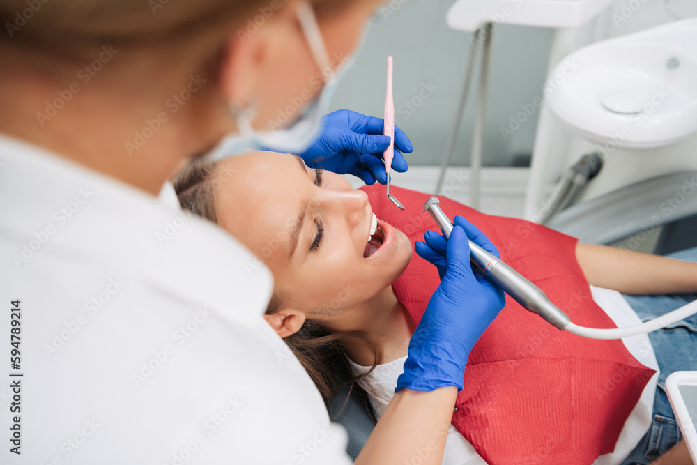 Portrait of a dentist who treats teeth of young woman patient. Portrait of a dentist who treats teeth of young woman patient.