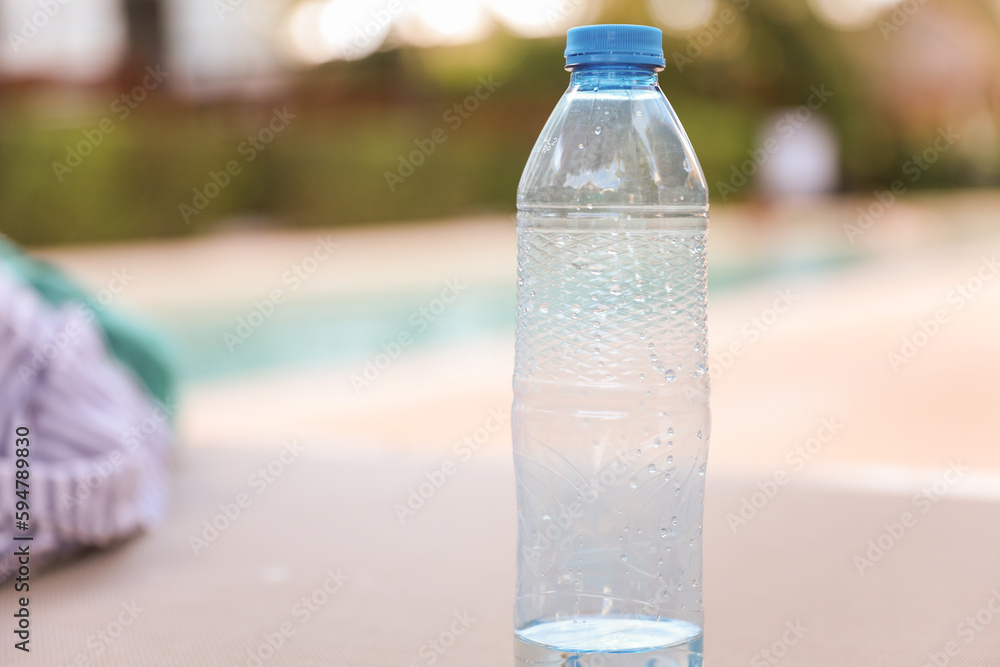 plastic bottles scattered around the pool and beach represent the negative impact of human activity on the environment. The pollution caused by single-use plastic bottles affects the ocean plastic bottles scattered around the pool and beach represent the negative impact of human activity on the environment. The pollution caused by single-use plastic bottles affects the ocean