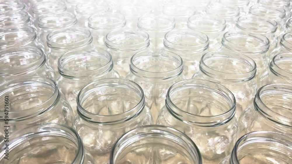 Rows of new clear glass jars for canning stand in the kitchen supply store Rows of new clear glass jars for canning stand in the kitchen supply store