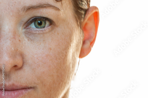 Naturally strong portrait half-sided of a woman without make-up with sun spots on her face photo