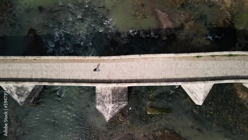 man running on historical bridge