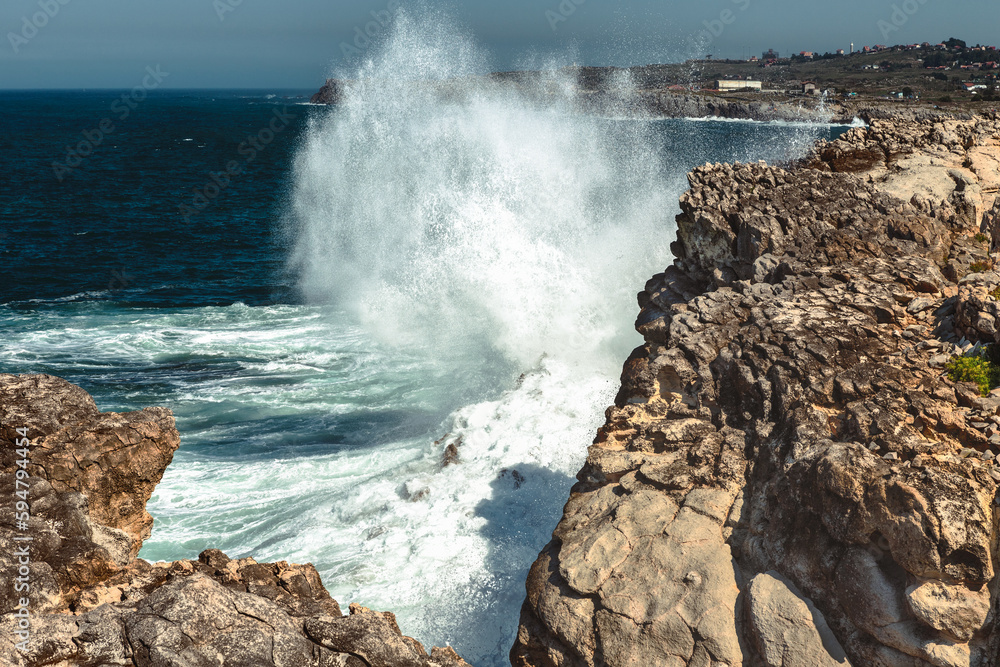 wave breaking against the rocks