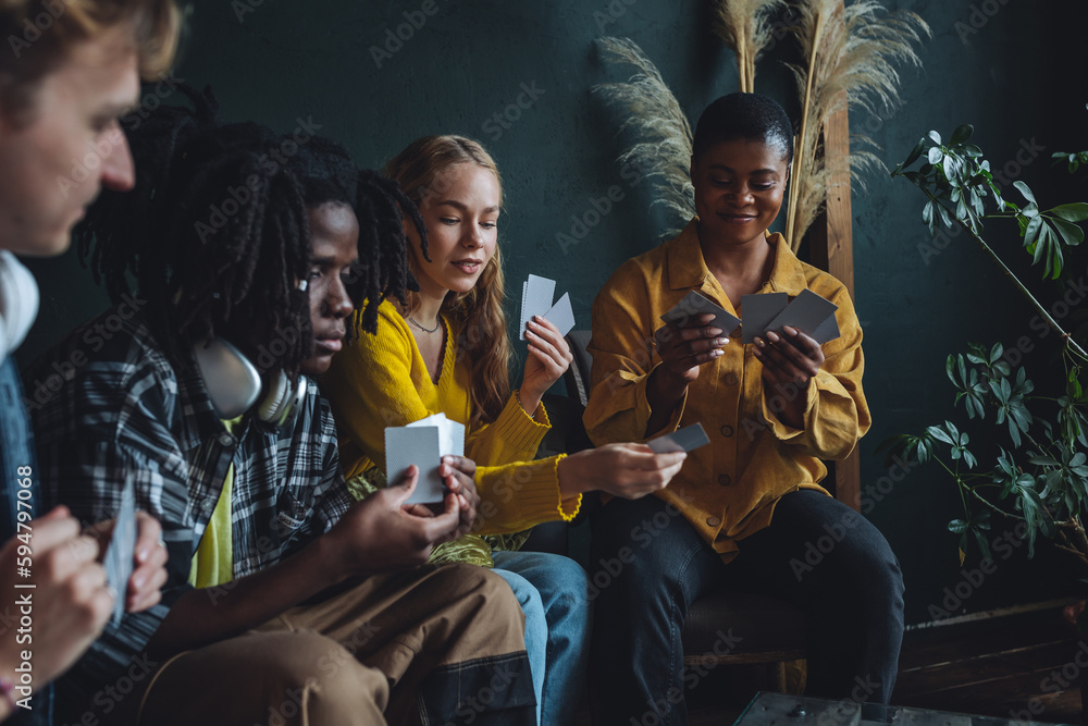 Group of diverse friends playing game on mobile phone Stock Photo