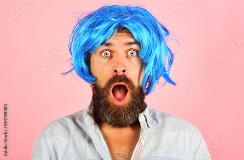 Surprised bearded man in blue wig. Party time. Fashion concept. Barbershop advertise. Handsome man with beard and mustache in colorful wig. Hipster in blue periwig. Amazed stylish guy with blue hair.