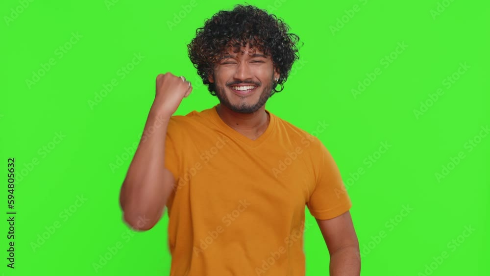 Happy joyful indian man shouting, raising fists in gesture I did it, celebrating success, winning, birthday, lottery jackpot goal achievemen, good news. Young hindu guy on green chroma key background Happy joyful indian man shouting, raising fists in gesture I did it, celebrating success, winning, birthday, lottery jackpot goal achievemen, good news. Young hindu guy on green chroma key background