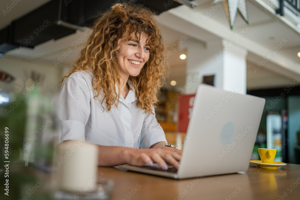 Woman use work on laptop from cafe happy smile adult caucasian Woman use work on laptop from cafe happy smile adult caucasian