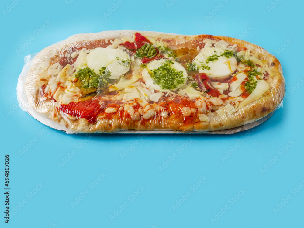 Italian style uncooked pizza on blue color background. Premium product with high quality ingredients. Italian style uncooked pizza on blue color background. Premium product with high quality ingredients.