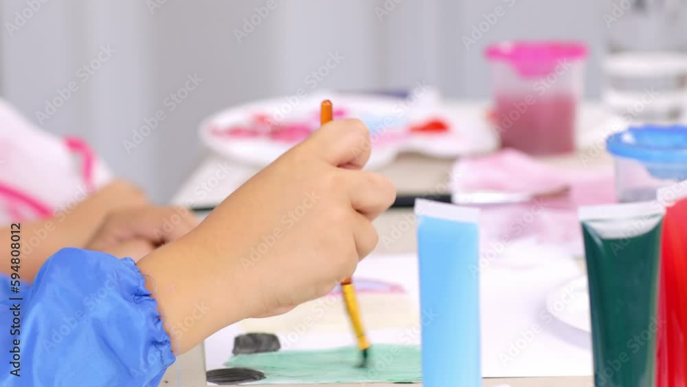 Boy and a girl are painting together Boy and a girl are painting together