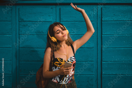 Happy woman listening to music in headphones