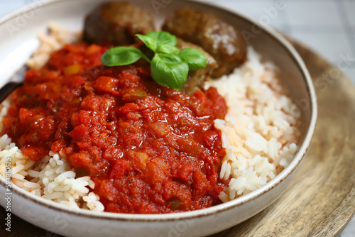 Rice with meatballs and tomato sauce. Healthy lunch or dinner.