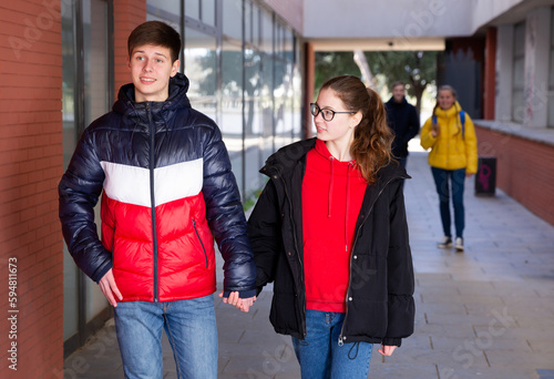 Young pretty couple of student boy and girl together outside happy smiling. Lifestyle people concept