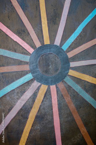 Colored Spokes of a Wheel on a Brown Background.
