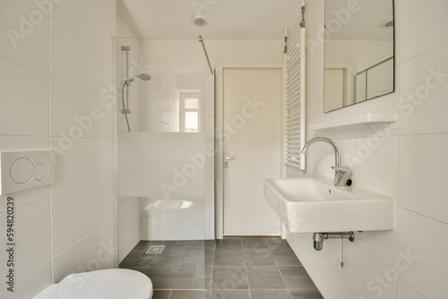 a bathroom with a toilet, sink, mirror and shower stall in the same color as seen on this photo