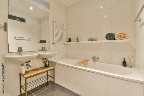 a bathroom with a sink, mirror and towel rack on the wall next to the bathtub in the corner
